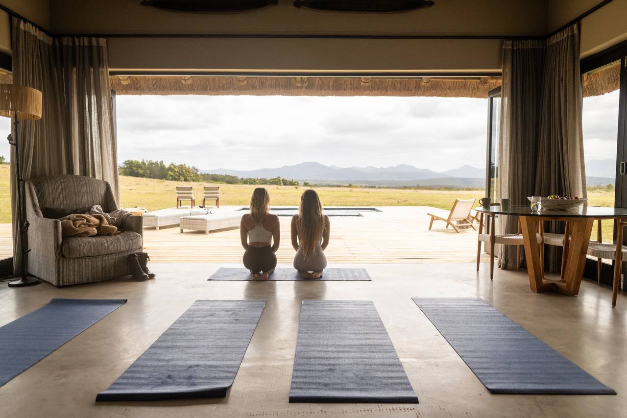 Nikkii and Kim practicing yoga at retreat